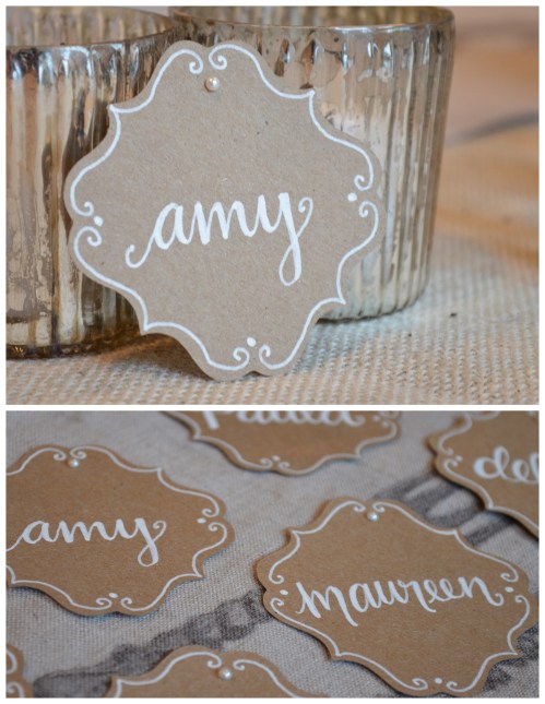 Kraft paper bracket place cards with white lettering and pearl detail 