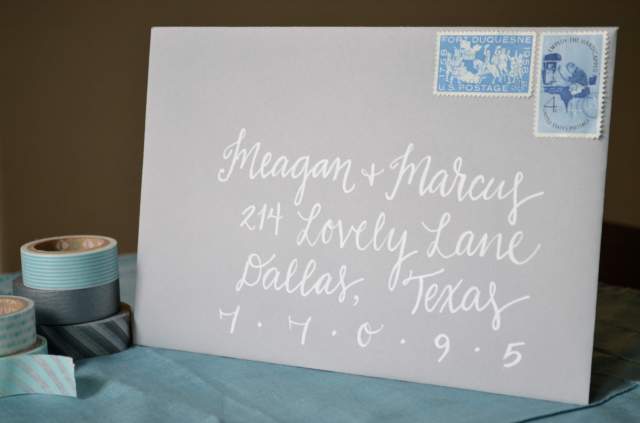 affordable white calligraphy lettering on grey envelope. teal. wedding shower. one charming life. 