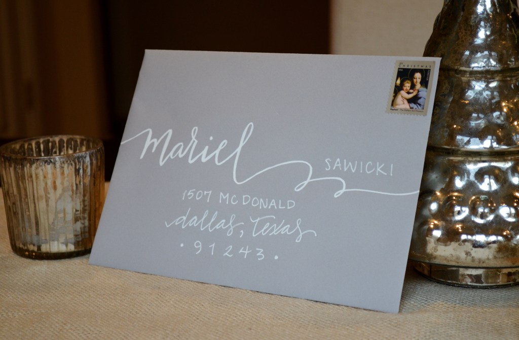 grey envelope with white lettering calligraphy from one charming life