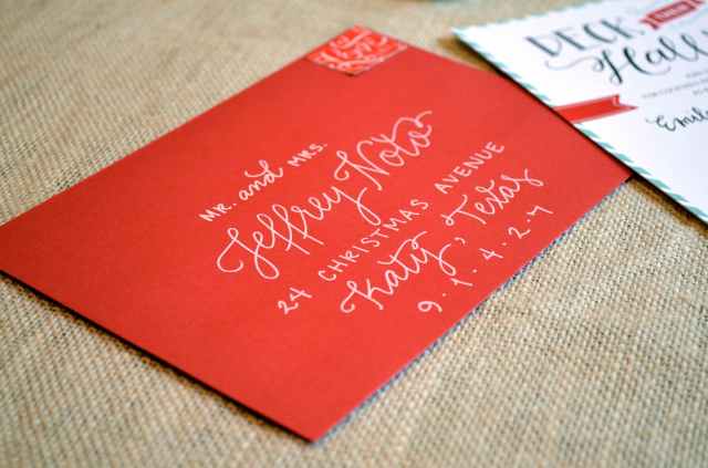 red envelope with white lettering from one charming life